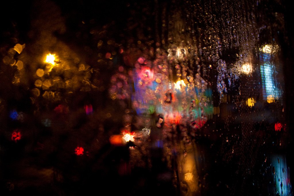 Blurred lights viewed through wet glass