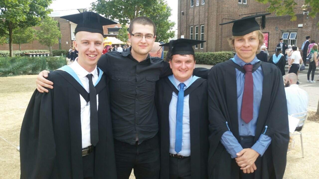 Jet graduating from University with three of his friends. Notably, Jet is not wearing a graduate gown.